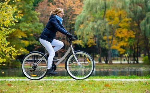 kvinde der cykler i en park
