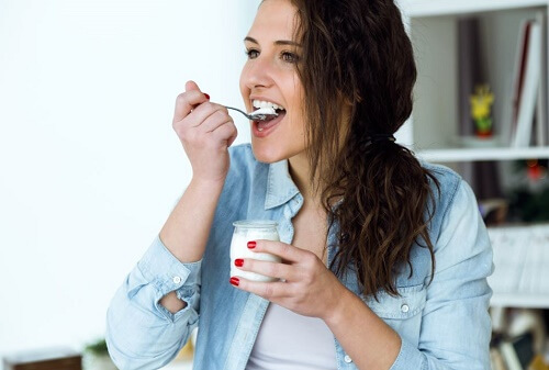 ragazza mangia uno yogurt