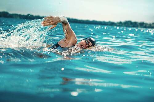 Atleta che nuota in acque libere.