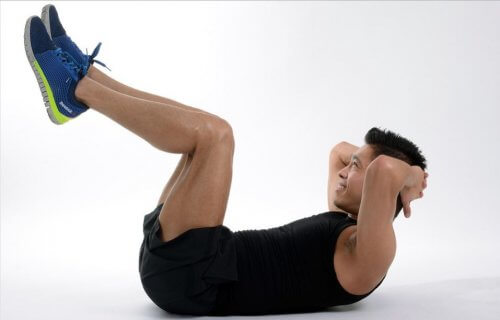 mężczyzna robi brzuszki - alternatywne treningi na mięśnie brzucha