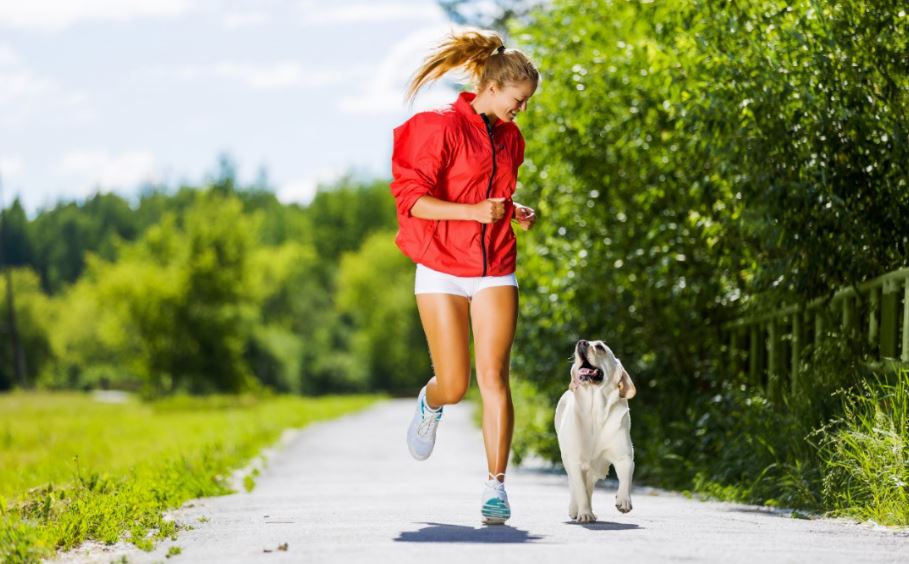 Garota correndo com o cachorro