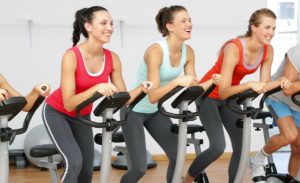Women doing spinning and indoor cycling.