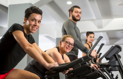 people on exercise machines keep going to the gym