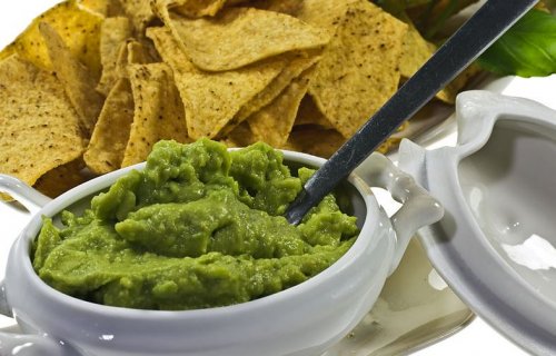 bowl of guacamole with tortilla chips