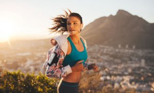 Woman implementing pace and running outdoors.