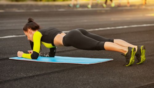 woman doing plank outside