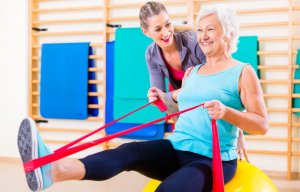 Woman doing rowing exercise with resistance band