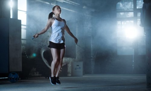 woman jumping rope in dark place exercises to strengthen your glutes at home
