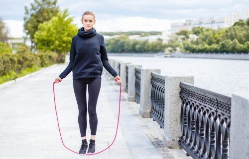 woman jumping rope by river