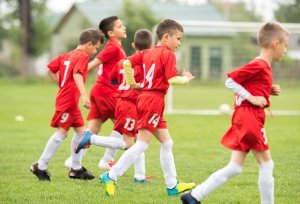 Benefits of teamwork. Children playing soccer. 