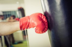Boxing glove hitting punching bag