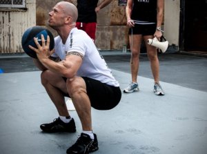 Man using a medicine ball to do squats
