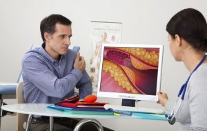 Doctor showing man cholesterol