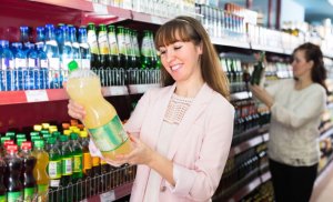 Women reading food labels in the supermarket.