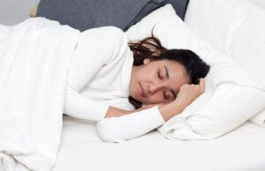 Woman getting rest in bed.