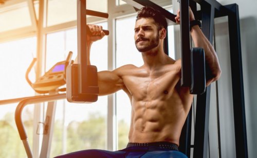 fit man on chest press machine at gym
