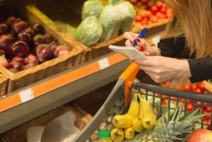 Woman shopping with a diet list.