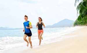 Couple running along the beach.