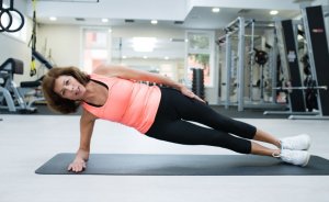 Woman doing ABT workout: side plank
