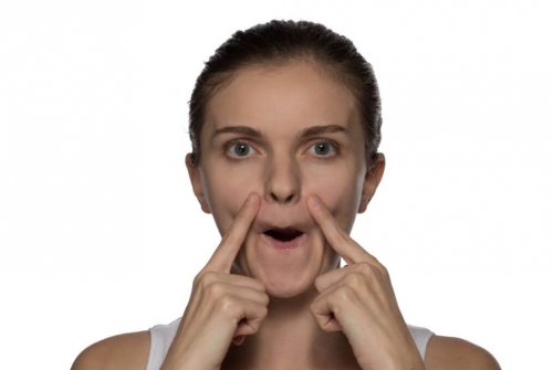 woman white background doing face yoga