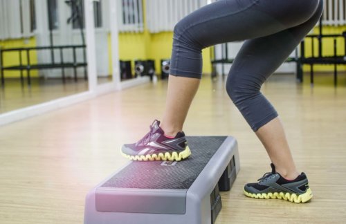 woman's legs stepping on an exercise step