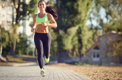 woman smiling running outside
