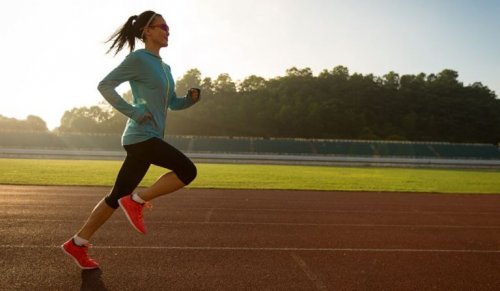 woman running on outdoor track benefits of running 30 minutes a day