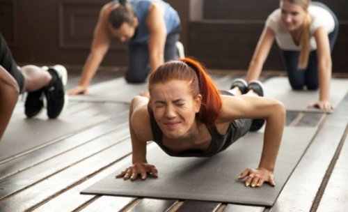 woman on mat straining with others resting