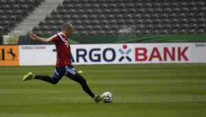 Arjen Robben kicking a ball.
