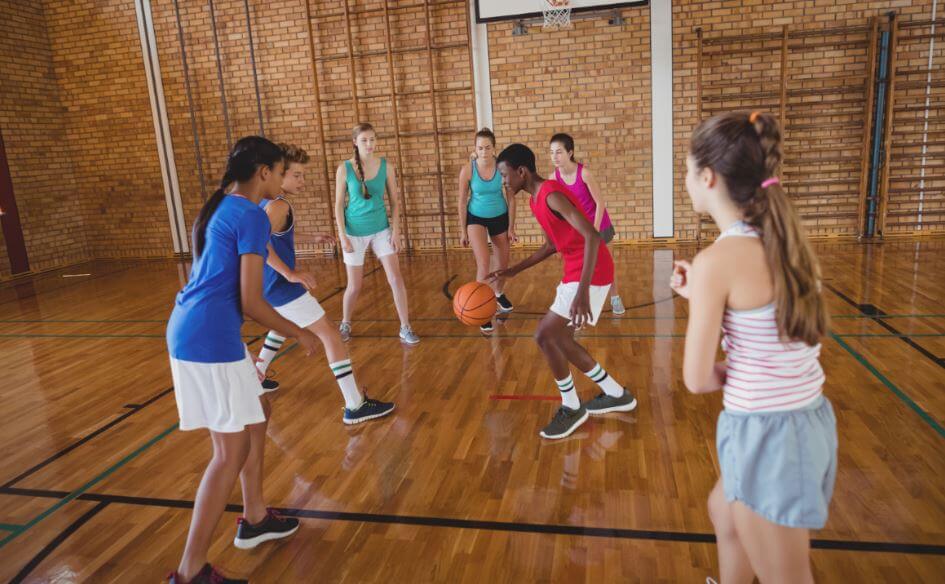 teens playing basketball