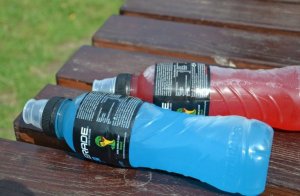 Two sports drinks in a bench.