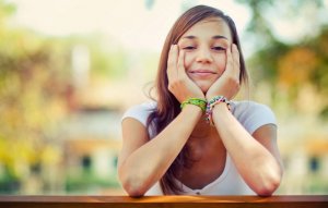 Happy girl sitting in a park.