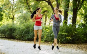 Two women running together.