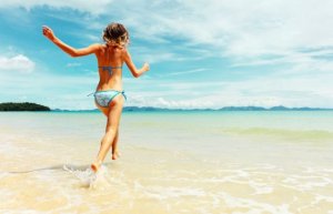 Girl running at the beach without worrying about losing muscle.