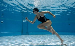 Woman sprinting in the water.