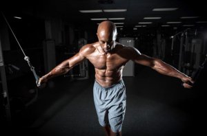 Man using a pulley machine as part of this routine to tone your chest.
