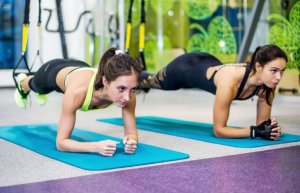 Two girls doing planks.
