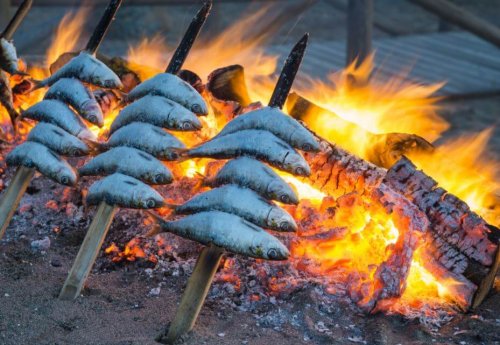 skewered sardines over embers Spain's typical healthy food