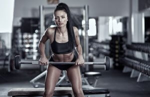 Woman doing Barbell Row in the gym.