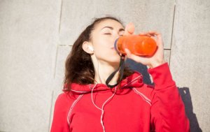 Woman drinking after running a marathon.