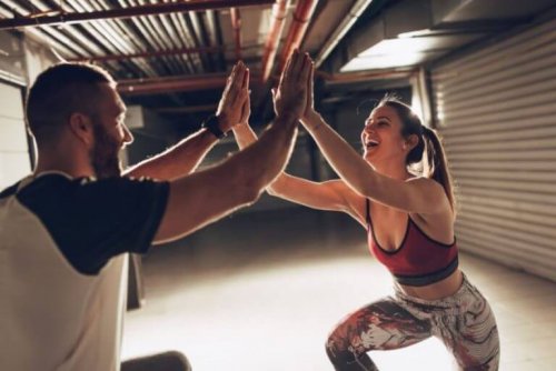 man and woman indoors high fiving