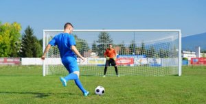 Soccer player scoring a goal.