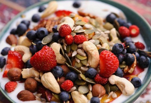 healthy breakfast bowl with nuts, dried fruit and yogurt