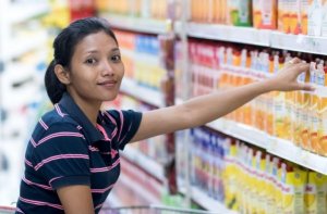 Woman buying bottled juices.