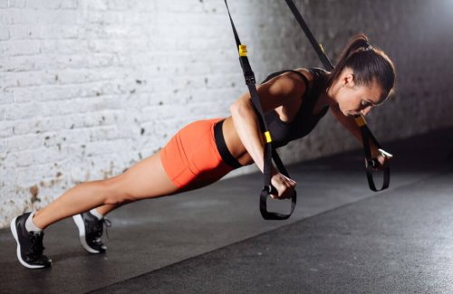 Woman doing chest press trx exercises for cyclists