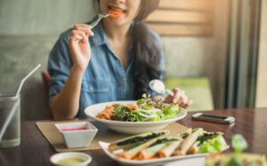Girl eating healthy foods as part of the holistic nutrition lifestyle
