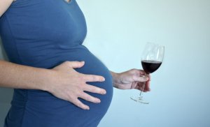 Pregnant woman drinking red wine