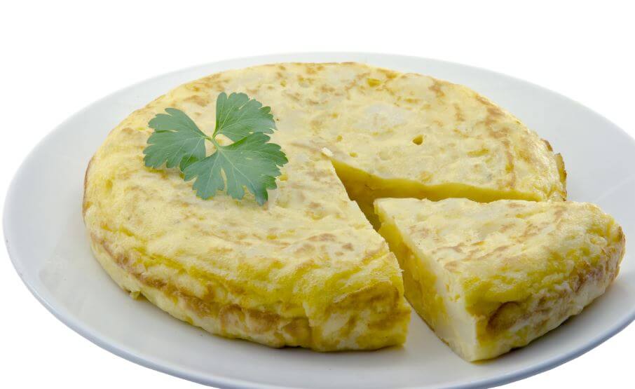 Freshly cooked microwave potato omelette with one slice out of it