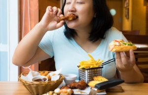 Woman not dieting and eating unhealthy food