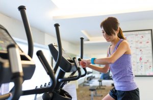 Woman on elliptical at gym